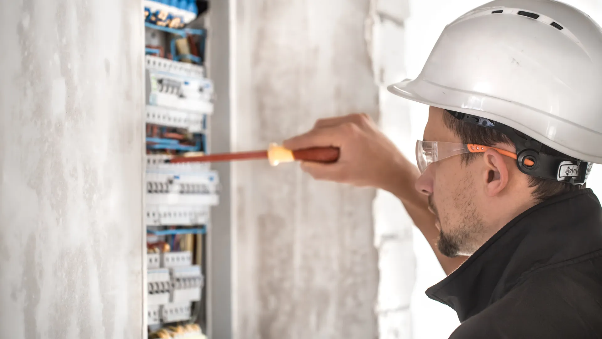 Field technician inspecting electrical equipment on a job site